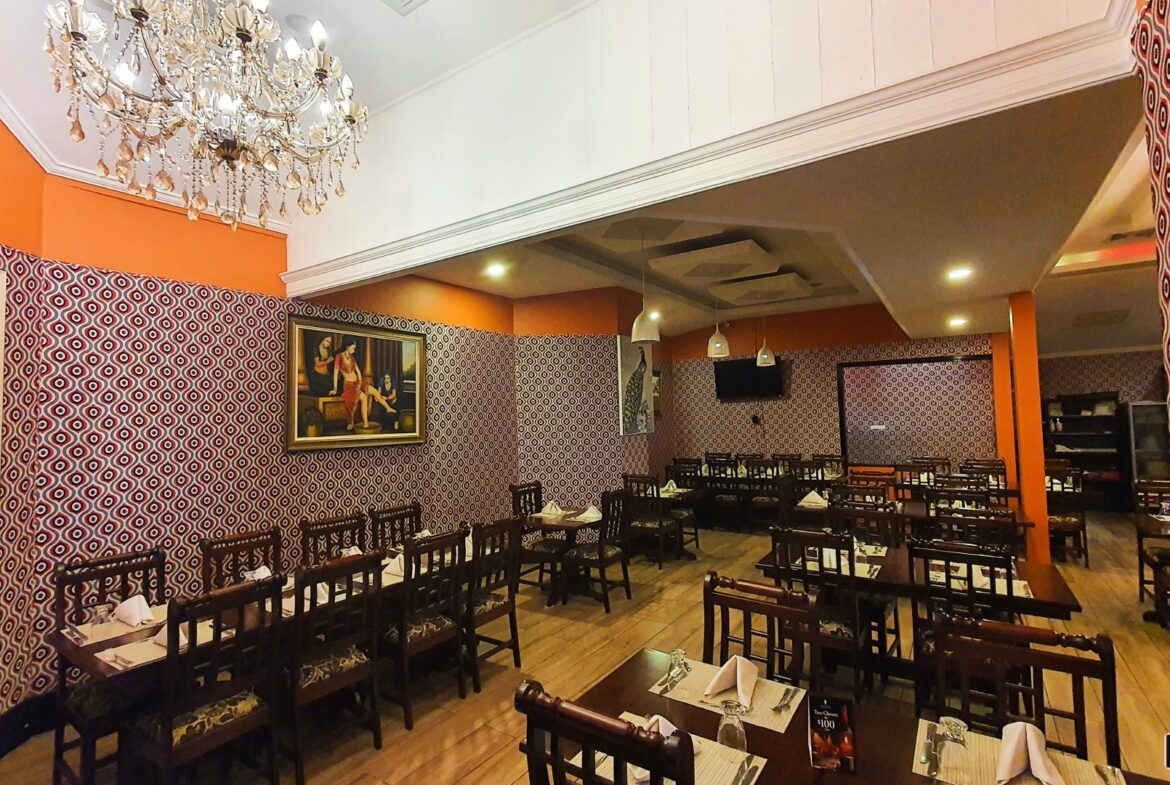 Restaurant interior with red leather booths and patterned flooring. "Prime Restaurant Space"