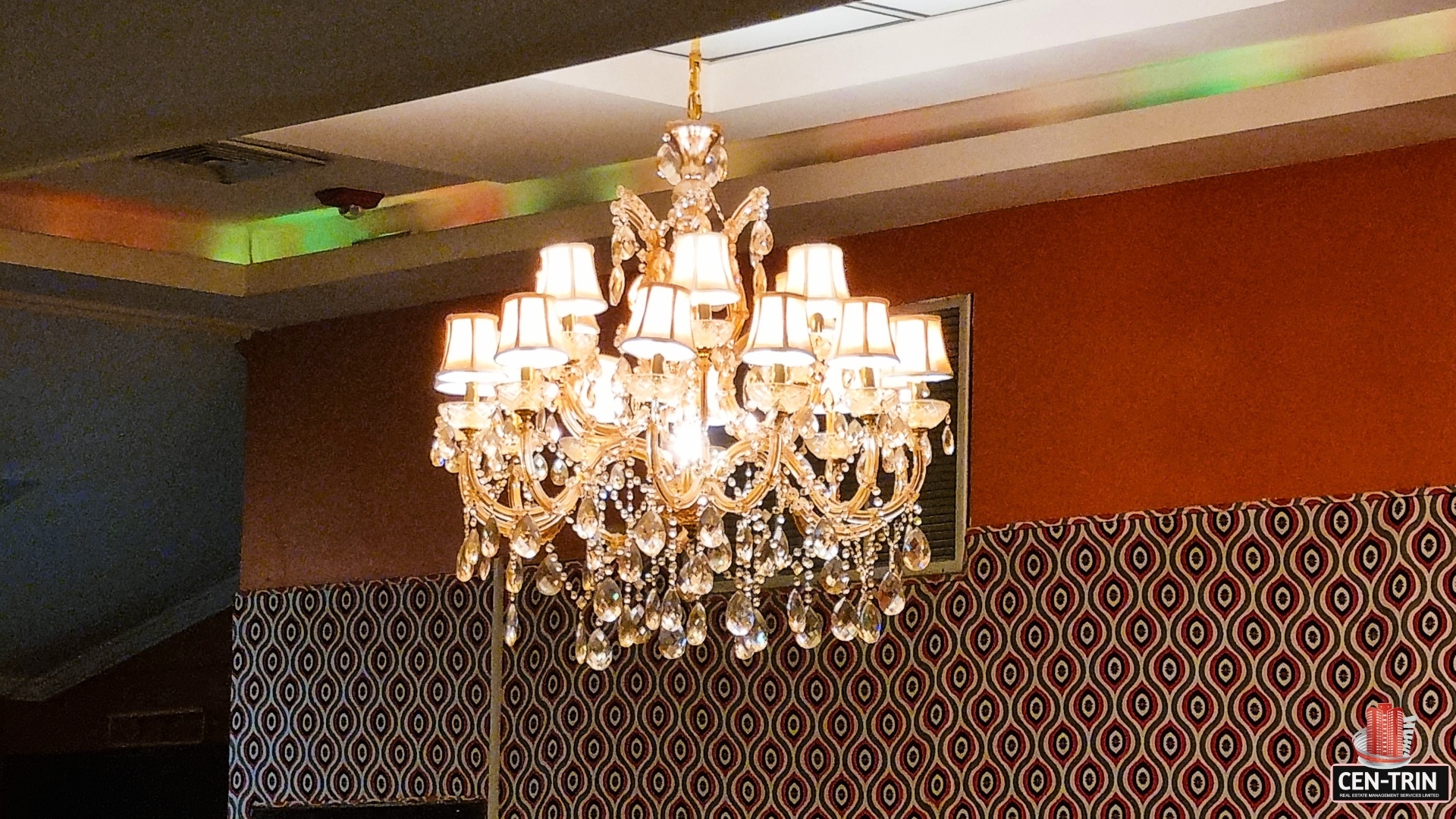 Close-up of a modern chandelier hanging from a ceiling. "Prime Restaurant Space" by Cen-Trin Real Estate.