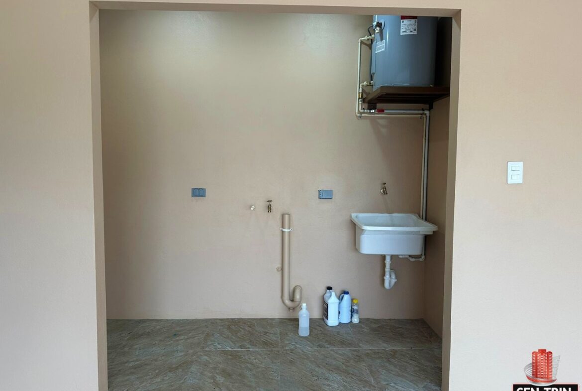 Laundry room with a sink, water heater, and washer and dryer