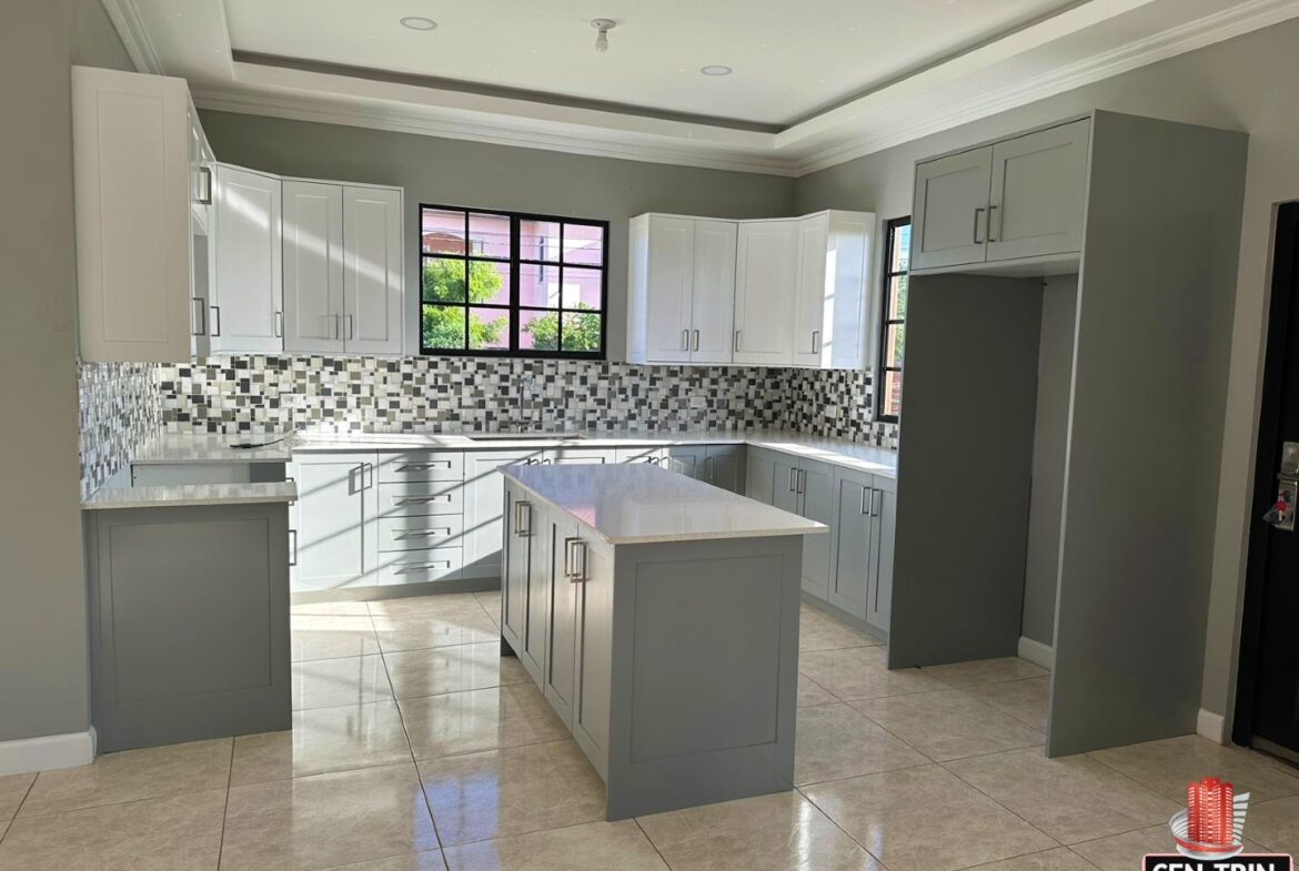 Modern kitchen with white cabinets, white island, and stainless steel appliances