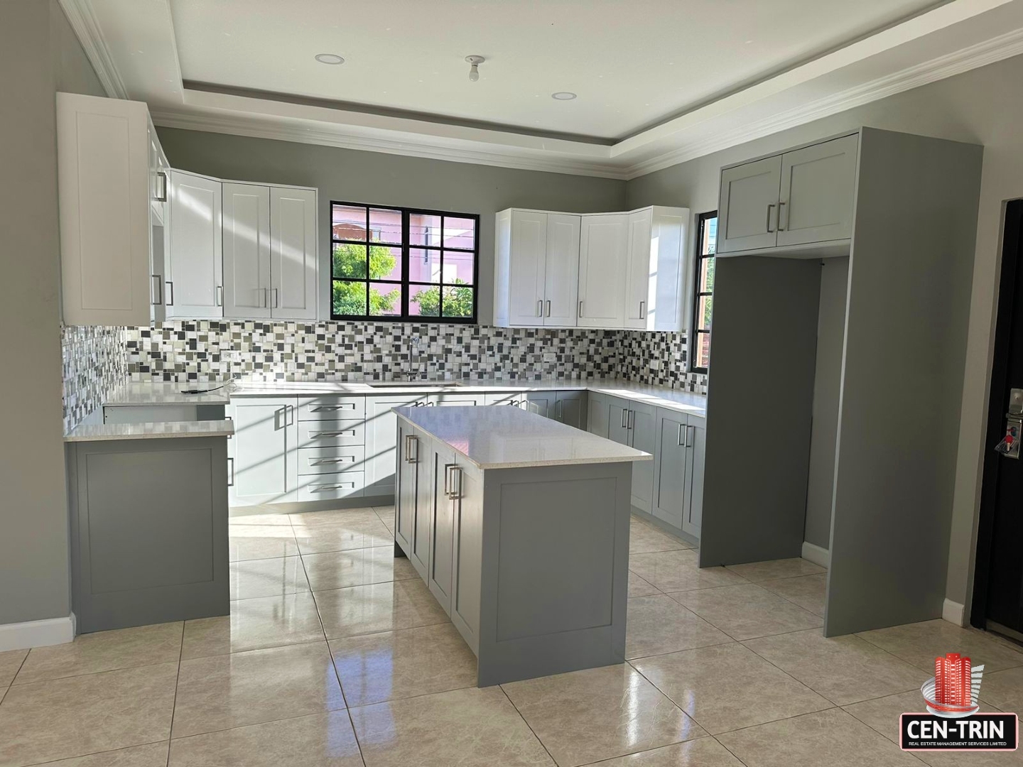 Modern kitchen with white cabinets, white island, and stainless steel appliances