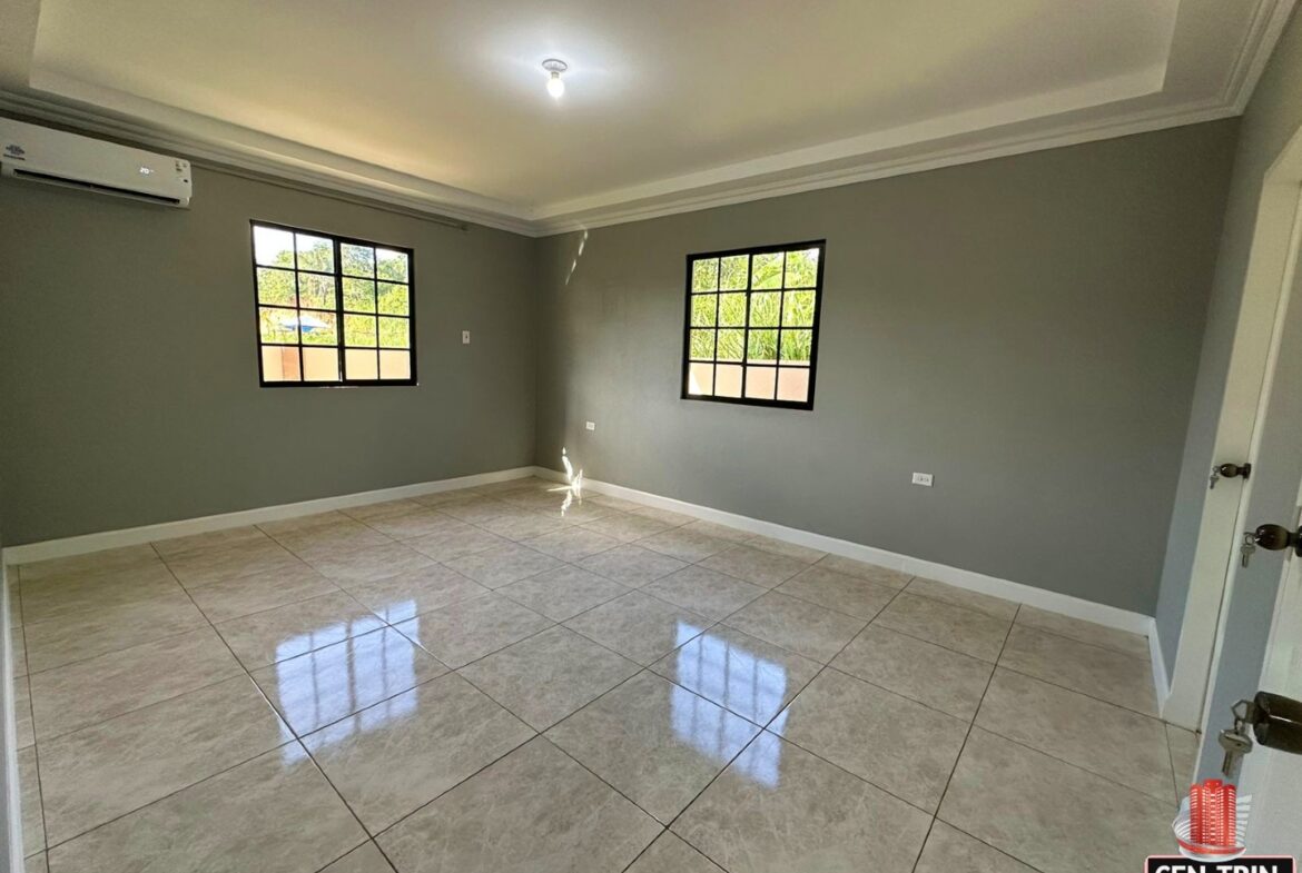 Bedroom with a tiled floor, two windows, and a doorway