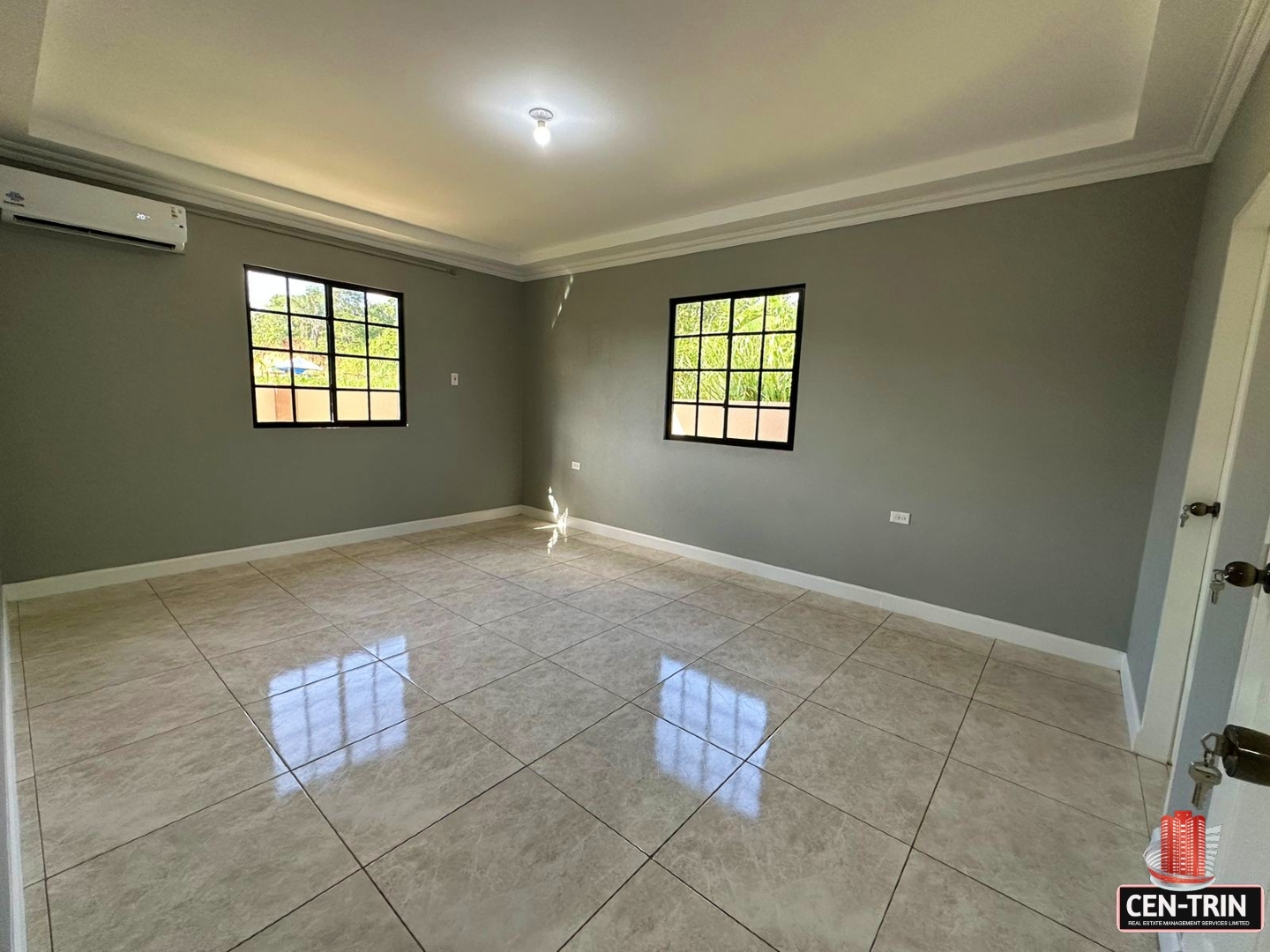 Bedroom with a tiled floor, two windows, and a doorway