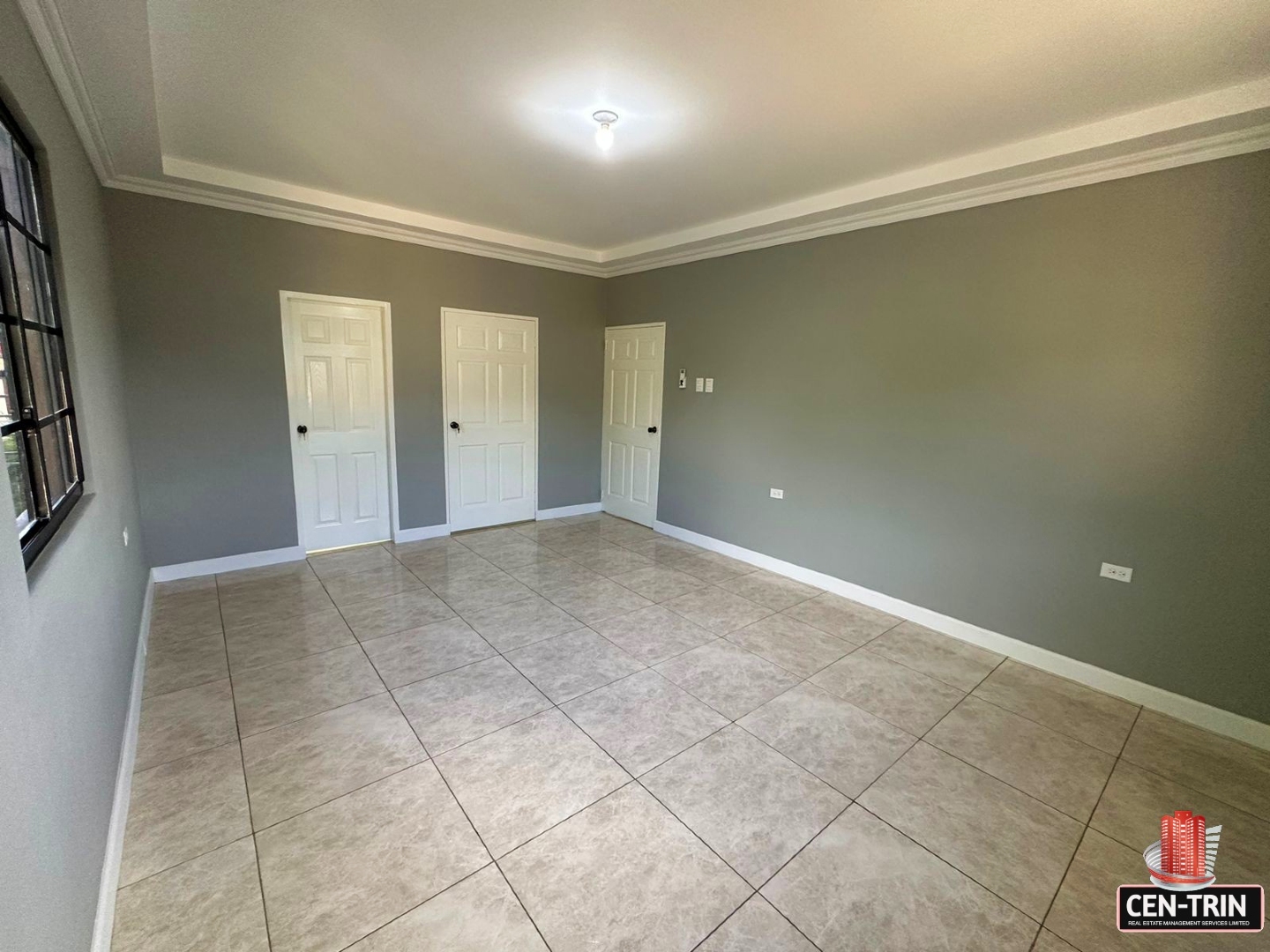 Master bedroom with enough space for a king-size bed, a walk-in closet, and a doorway leading to a bathroom.