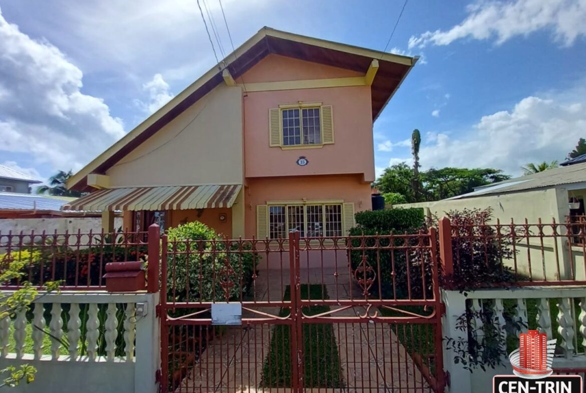 The front of a 3-Bedroom House for Sale with a red gate
